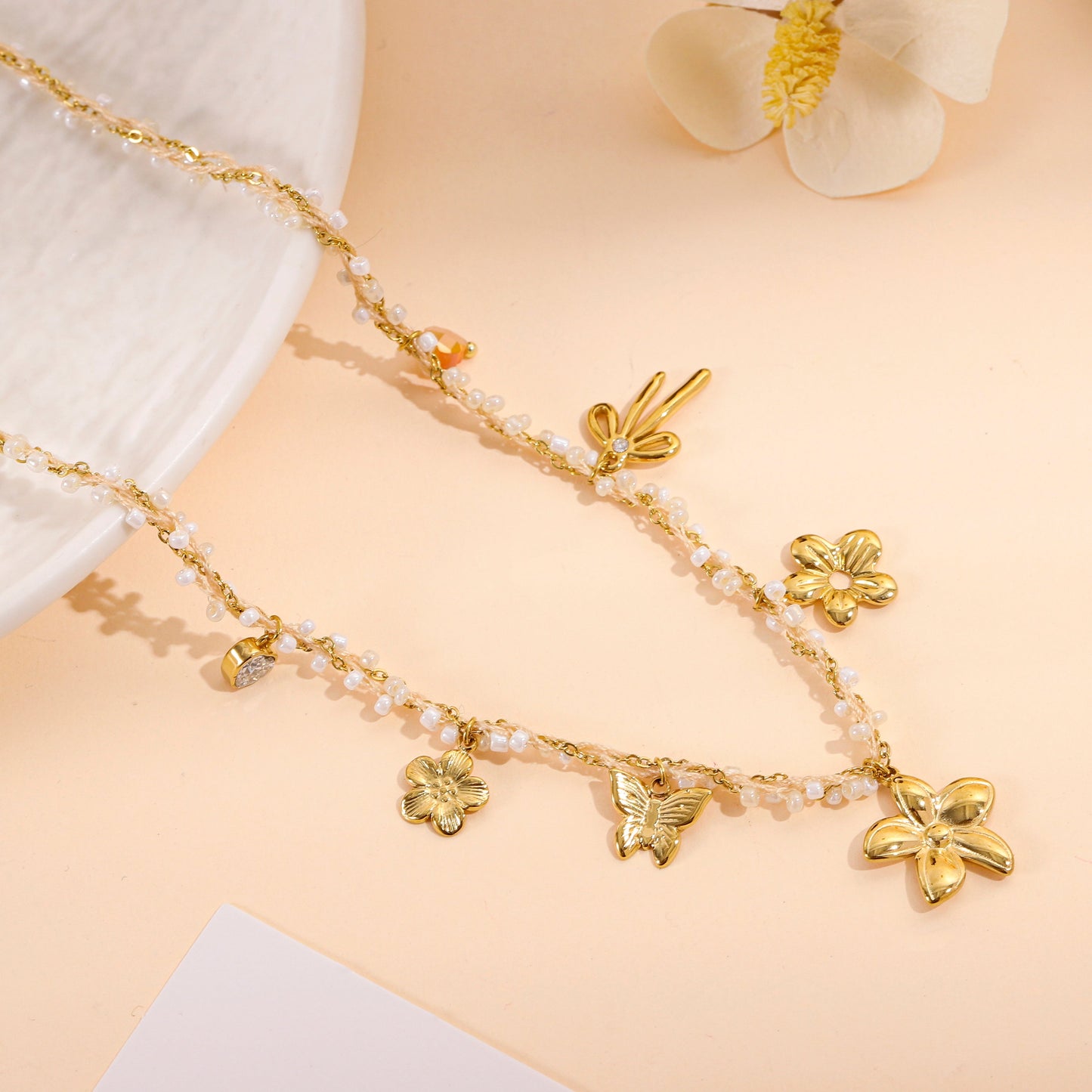 Collier doré à perles fines et charms floraux